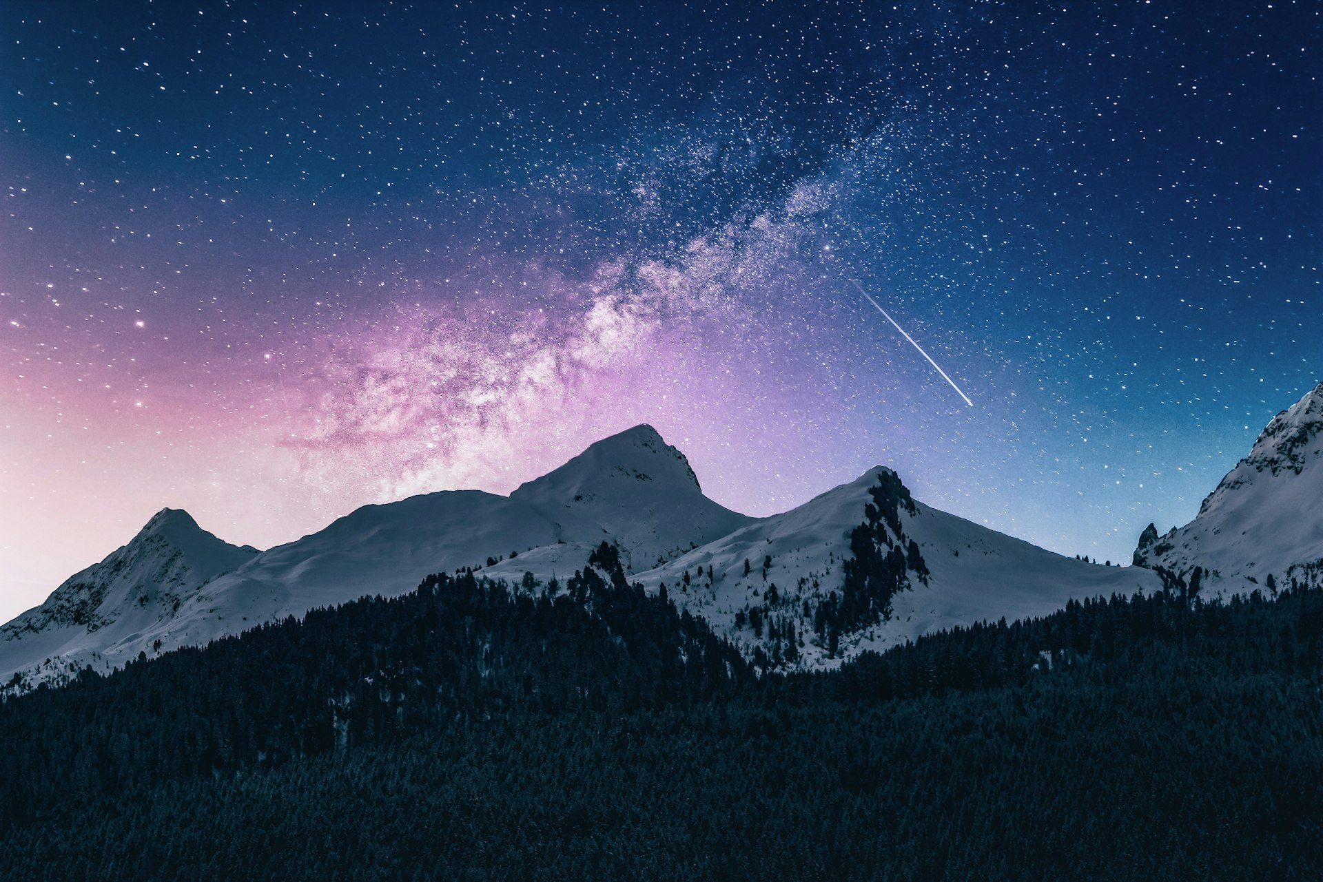 Mist rising over a mountain ridge at dawn